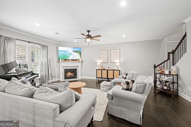 living room featuring crown molding, ceiling fan, and dark hardwood / wood-style flooring