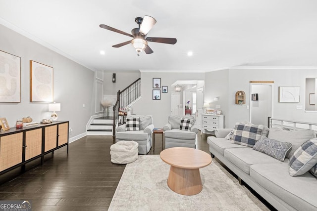 living room featuring ornamental molding, dark wood-type flooring, and ceiling fan