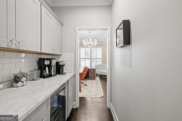 bar with wine cooler, light stone counters, tasteful backsplash, dark hardwood / wood-style floors, and white cabinets