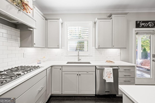 kitchen featuring premium range hood, sink, stainless steel dishwasher, gas cooktop, and gray cabinets