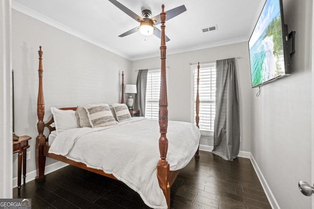 bedroom featuring dark hardwood / wood-style flooring, crown molding, and ceiling fan