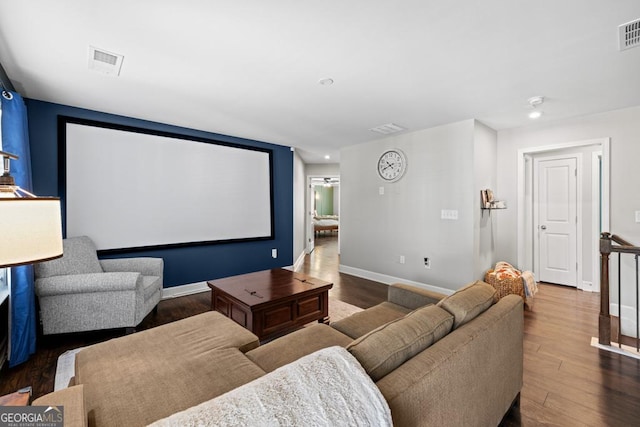 cinema room with dark hardwood / wood-style flooring