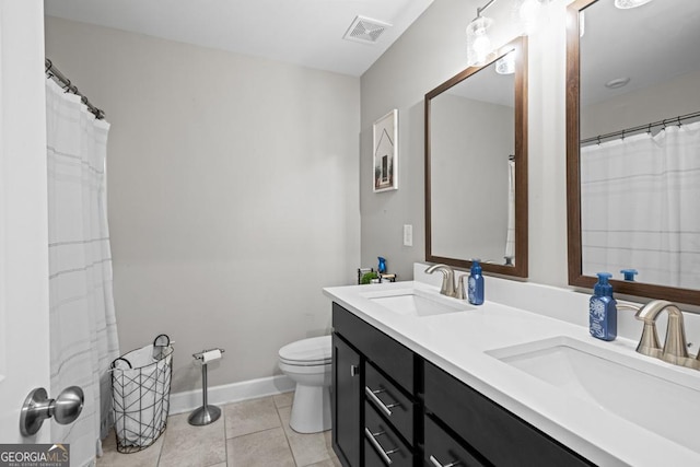 bathroom with tile patterned flooring, vanity, and toilet