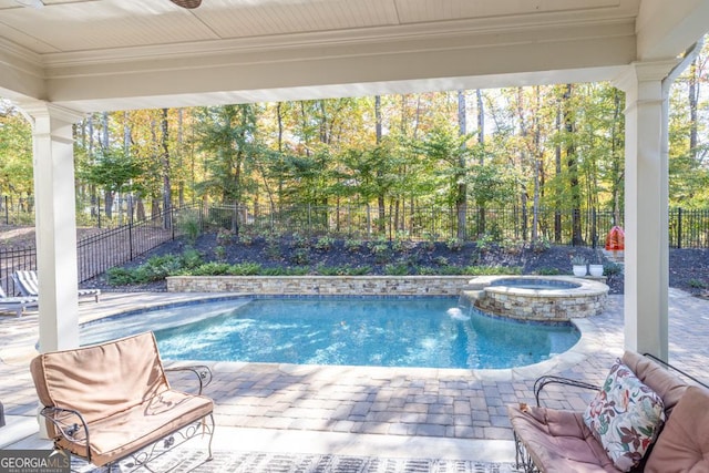 view of swimming pool featuring a patio area, ceiling fan, and an in ground hot tub