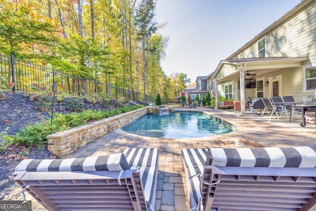 view of pool with ceiling fan and a patio area