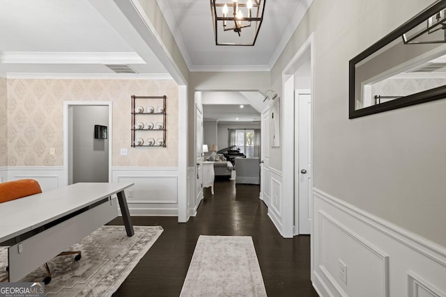 interior space featuring crown molding, dark hardwood / wood-style flooring, and a chandelier