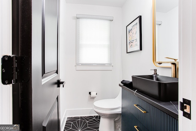 bathroom with vanity, toilet, and tile patterned flooring