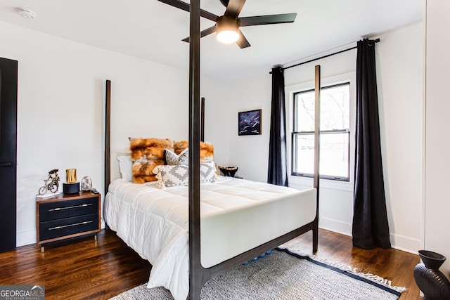 bedroom featuring dark hardwood / wood-style flooring and ceiling fan