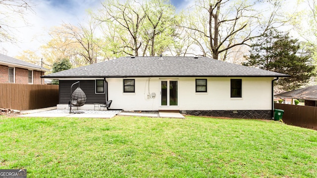 rear view of property with a lawn and a patio area