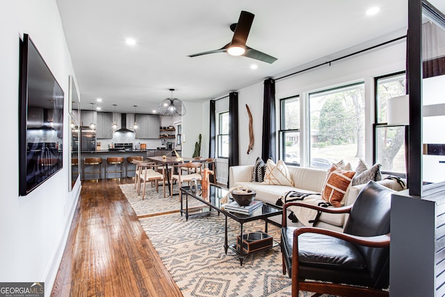 living room featuring dark hardwood / wood-style floors and ceiling fan