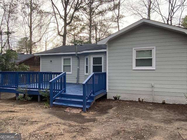back of house featuring a wooden deck