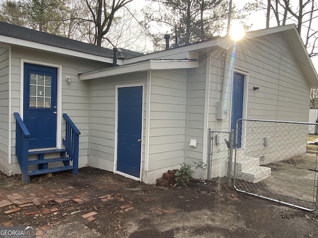 view of side of property featuring fence and entry steps