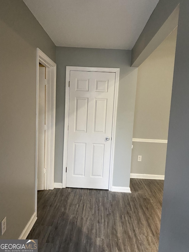 hallway with dark wood-type flooring