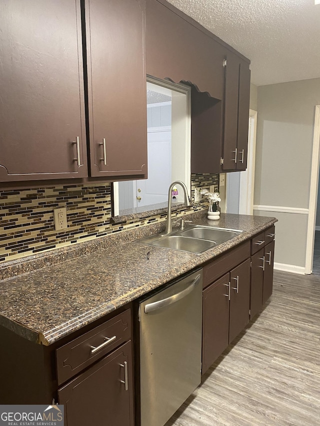 kitchen with decorative backsplash, a sink, dark brown cabinetry, dishwasher, and light wood finished floors