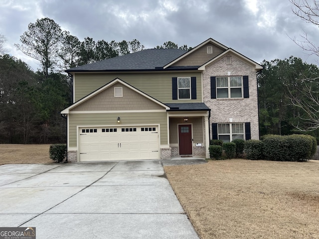 craftsman house featuring driveway, brick siding, and a shingled roof