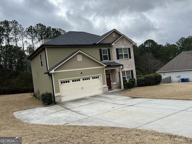 craftsman-style home featuring a garage, brick siding, driveway, and roof with shingles