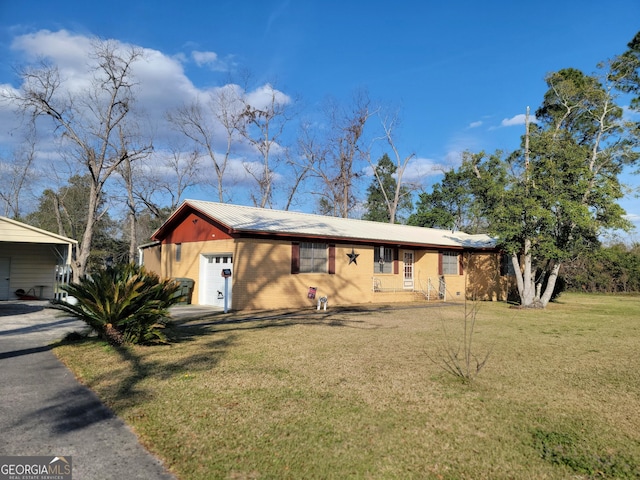 single story home with a garage, brick siding, metal roof, and a front lawn