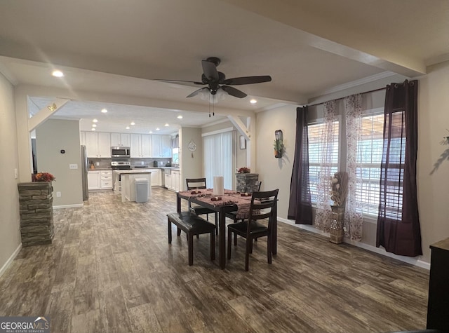 dining area featuring crown molding, hardwood / wood-style flooring, and ceiling fan