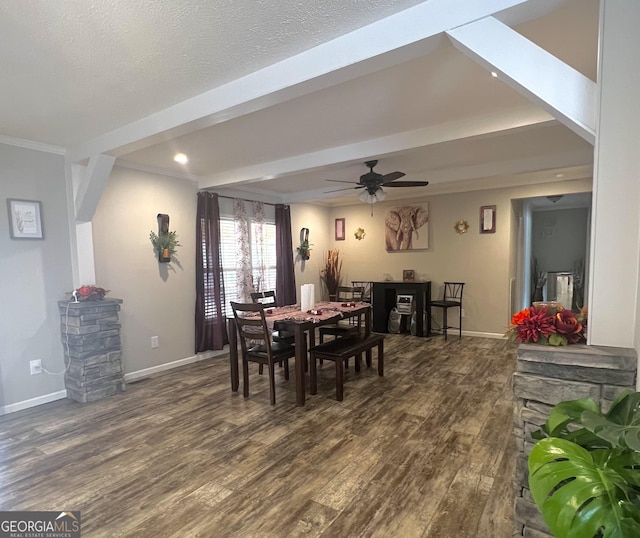 dining room with crown molding, a textured ceiling, dark wood-type flooring, and ceiling fan