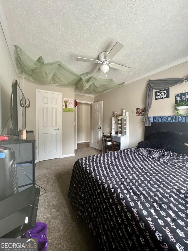 carpeted bedroom with ceiling fan and a textured ceiling