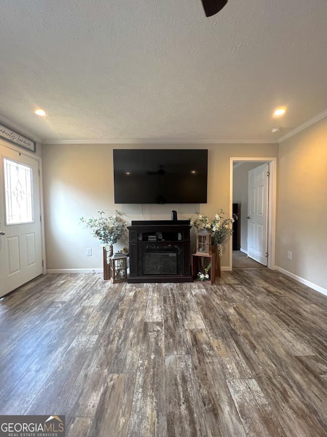 living room featuring wood-type flooring, a textured ceiling, and crown molding