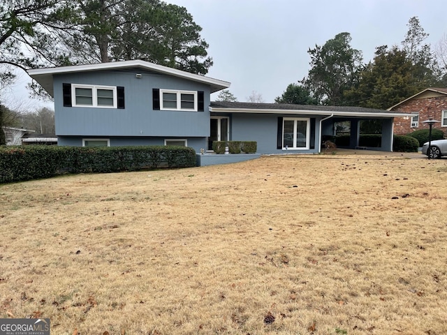 split level home featuring a carport and a front yard