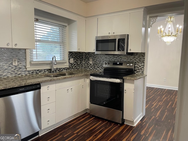 kitchen featuring white cabinetry, stainless steel appliances, dark wood-type flooring, and stone counters