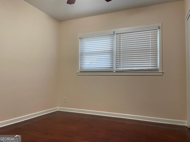 spare room featuring ceiling fan and dark hardwood / wood-style floors