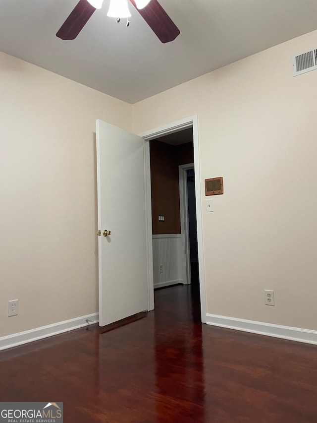 unfurnished room with ceiling fan and dark hardwood / wood-style floors