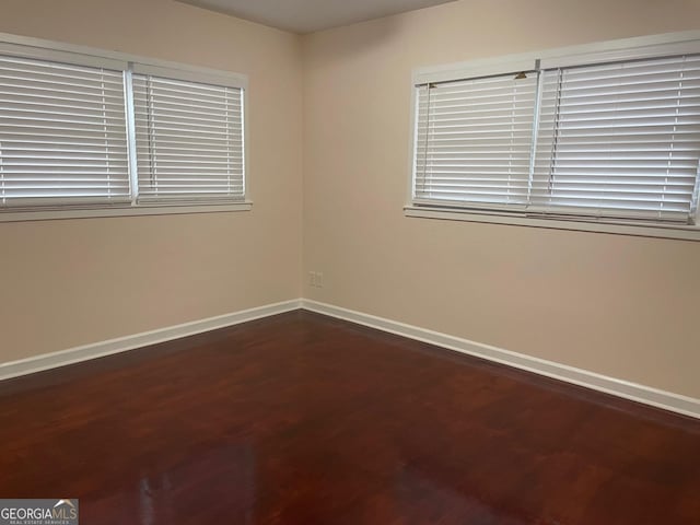 unfurnished room with dark hardwood / wood-style floors