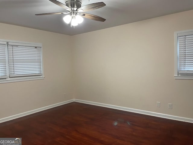 unfurnished room featuring dark wood-type flooring and ceiling fan