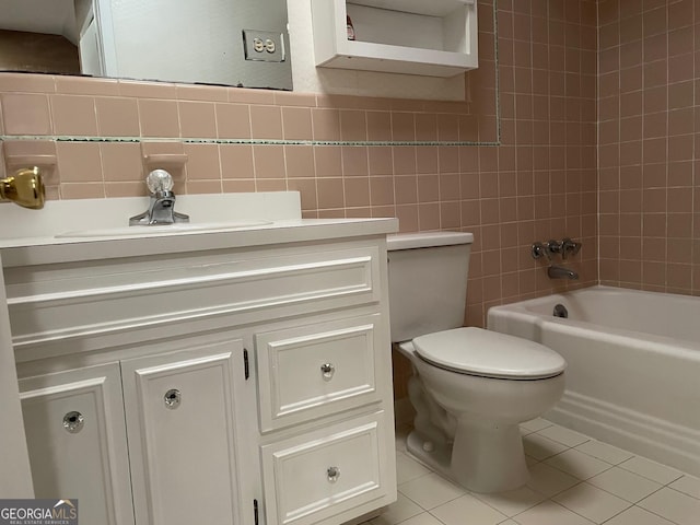 full bathroom featuring tile patterned flooring, vanity, tile walls, and toilet