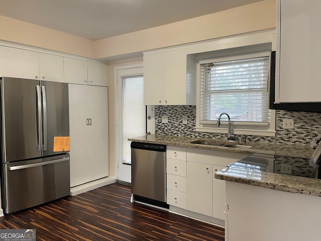 kitchen featuring sink, appliances with stainless steel finishes, white cabinetry, light stone counters, and dark hardwood / wood-style flooring