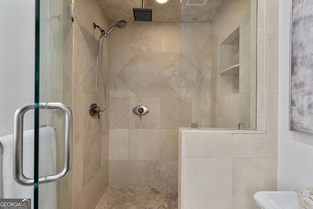 bathroom featuring a shower with door