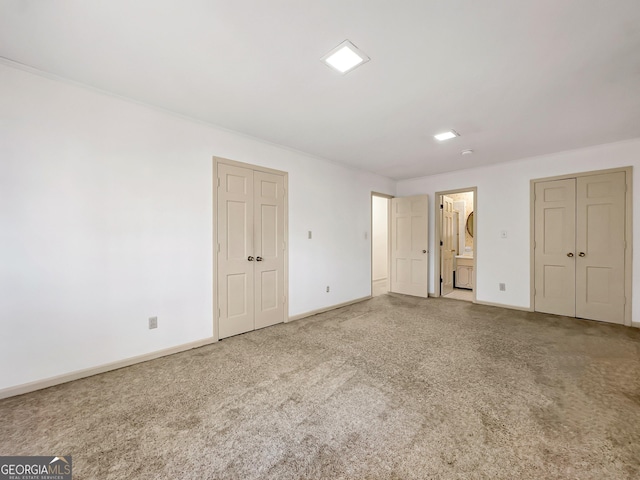 unfurnished bedroom with carpet and connected bathroom