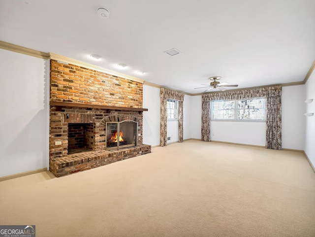 unfurnished living room with crown molding, ceiling fan, a fireplace, and carpet floors