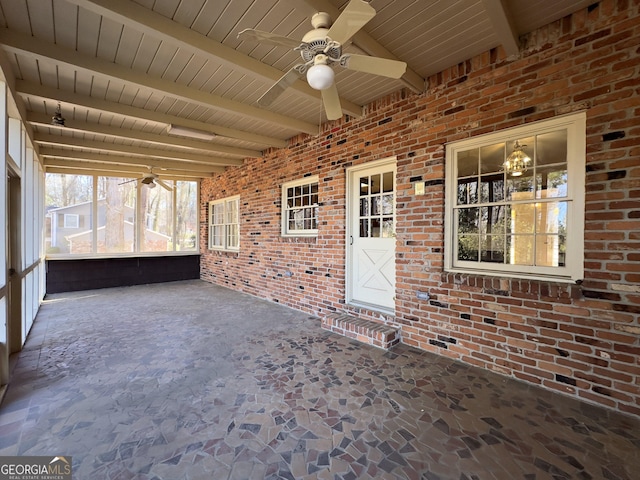 unfurnished sunroom with beamed ceiling, wood ceiling, and ceiling fan