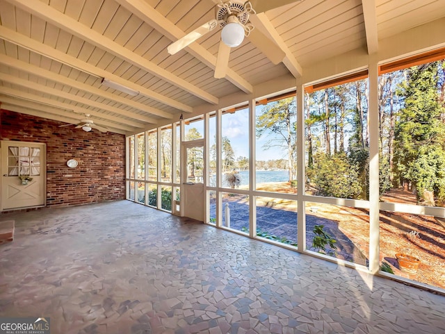 unfurnished sunroom featuring ceiling fan, a water view, and beam ceiling