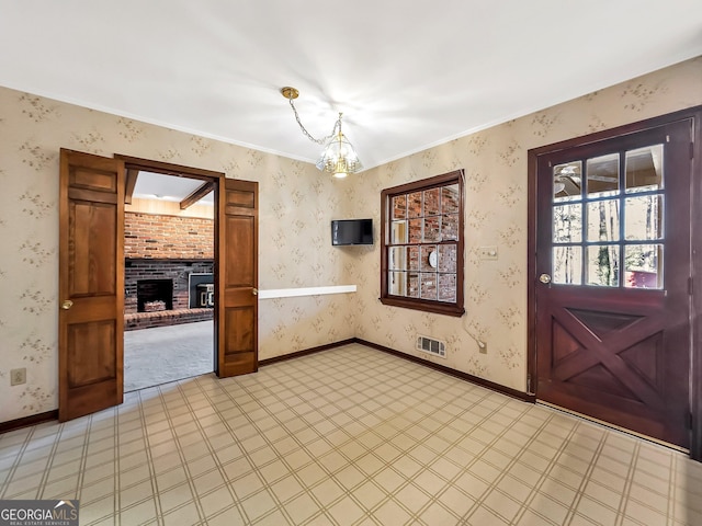 interior space with a fireplace and a chandelier