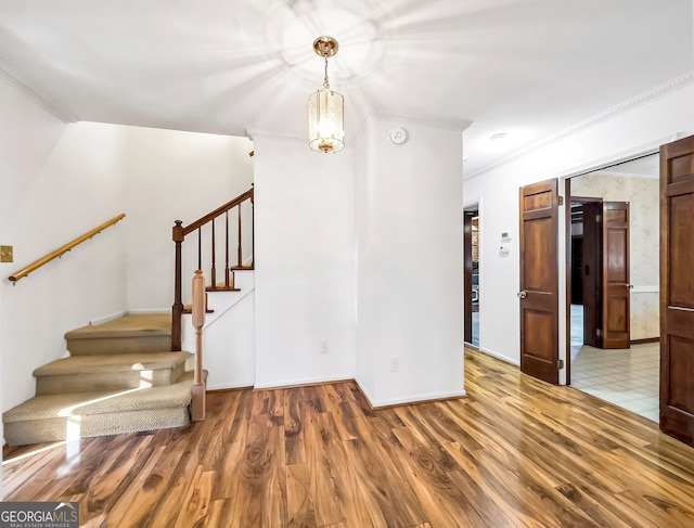 interior space with crown molding and hardwood / wood-style floors