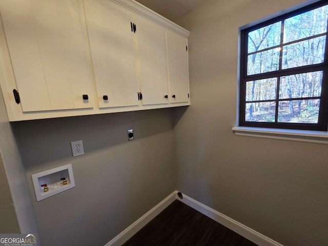 laundry area featuring dark wood-type flooring, cabinets, washer hookup, and hookup for an electric dryer