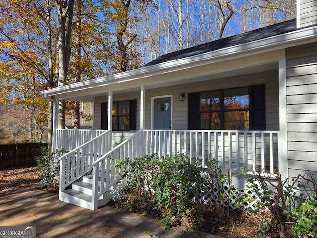 view of exterior entry featuring covered porch