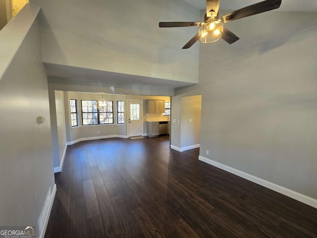 unfurnished living room featuring ceiling fan, dark hardwood / wood-style flooring, and a towering ceiling