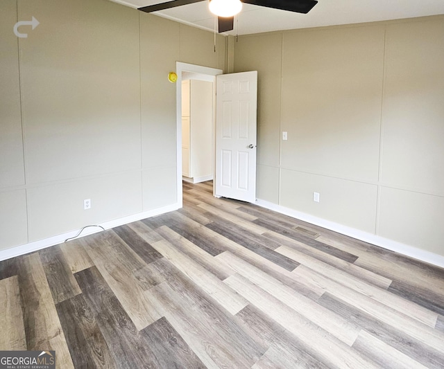 spare room featuring ceiling fan and light wood-type flooring