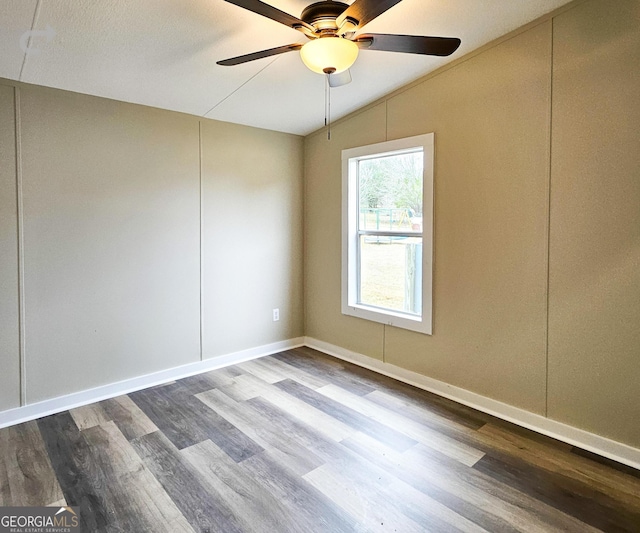 unfurnished room featuring hardwood / wood-style flooring, vaulted ceiling, and ceiling fan