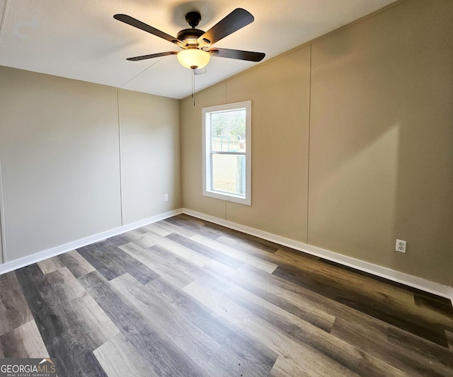 spare room with hardwood / wood-style flooring, lofted ceiling, and ceiling fan