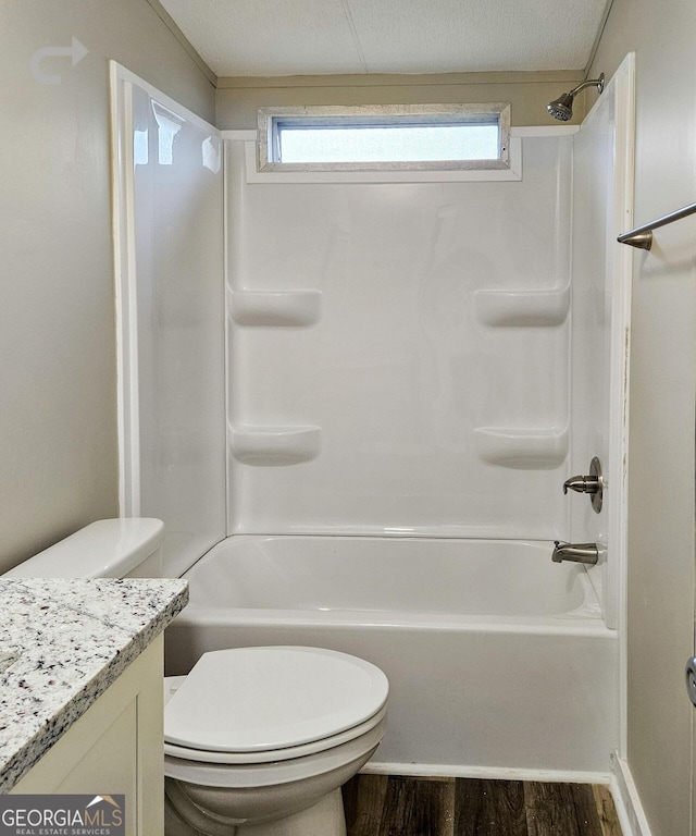 full bathroom with vanity, hardwood / wood-style flooring, toilet, and washtub / shower combination