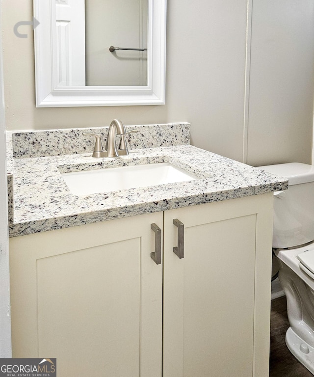 bathroom featuring vanity and toilet