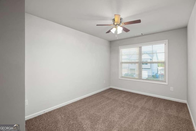 spare room featuring carpet floors and ceiling fan