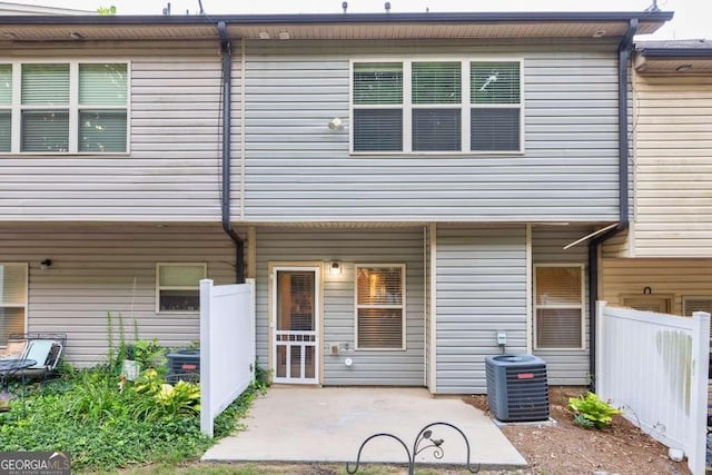 rear view of property with a patio area and central air condition unit